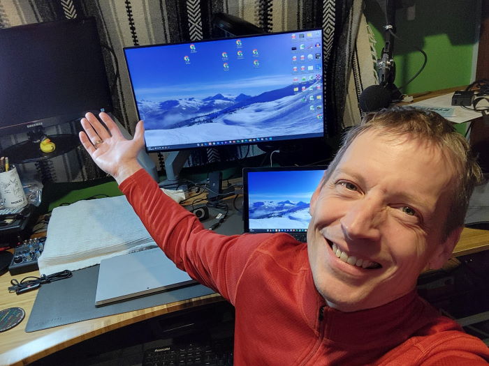 Jon smiling while sitting at his computer desk